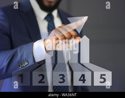 Businessman drawing growth 3D diagram with finger Stock Photo