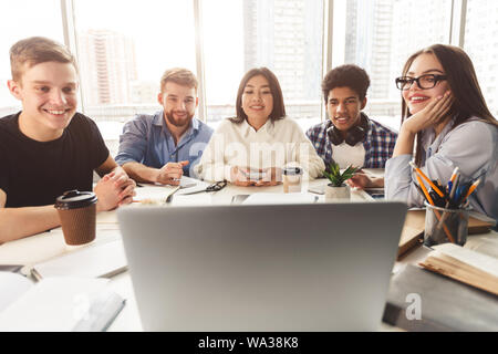 Online lesson. Students learning by laptop in library Stock Photo
