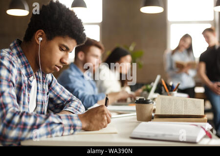 Student guy doing homework and preparing for exam Stock Photo