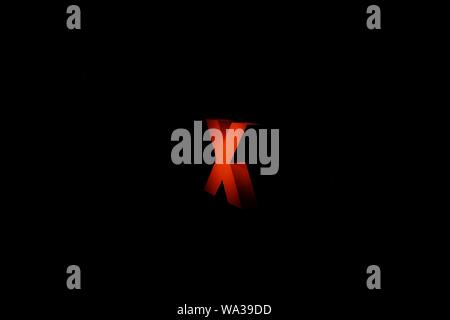 Wide shot of a red X sign on a black background Stock Photo