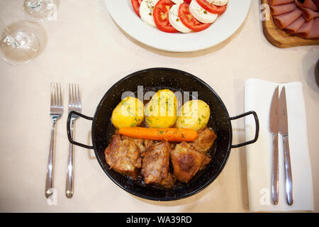 cooked beef with boiled potatoes and carrots served in a metal container, top view Stock Photo