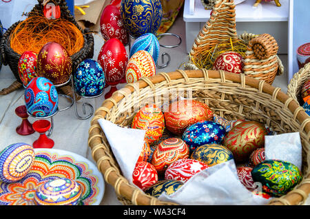 Ceramic plates, hand-painted wooden souvenirs are on the counter at the festive fair. Stock Photo