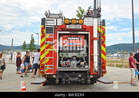Open back side of red German fire truck with water supply connection Stock Photo