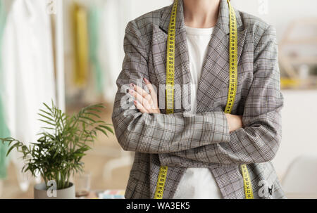 Female fashion designer with arms crossed in design studio Stock Photo