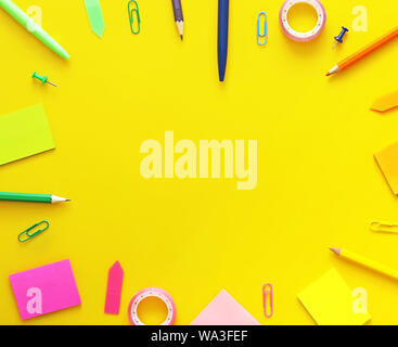 Colorful school items as a frame on yellow background. Flat lay, top view. Back to school concept Stock Photo