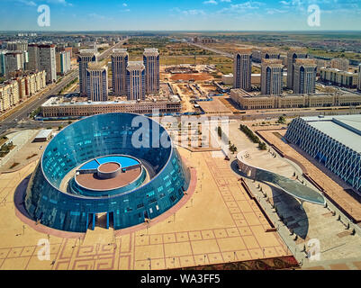 NUR-SULTAN, KAZAKHSTAN - August 11, 2019: Beautiful panoramic aerial drone view to Nursultan (Astana) city center with skyscrapers and Shabyt Palace o Stock Photo