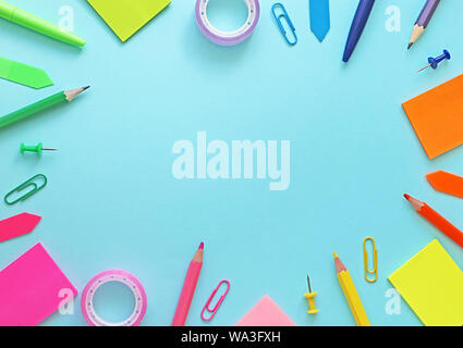 Colorful school items as a frame on blue background. Flat lay, top view. Back to school concept Stock Photo