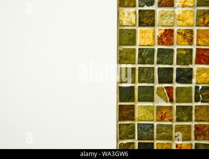 view of some tiles on a bathroom wall from above, white and coloured mosaic, decoration background Stock Photo