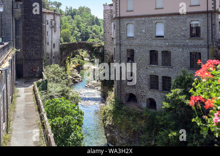 Magra River with the ancient bridge between the houses of Bagnone, a beautiful ancient town in Tuscany, Italy Stock Photo