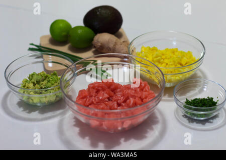I took this photograph the ingredients chopped and prepared to cook a salmon tartar. These ingredients are avocado, mango, salmon, chives, lime and gi Stock Photo