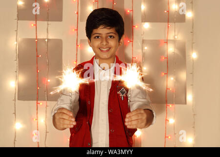Boy burning phooljhadi on Diwali Stock Photo