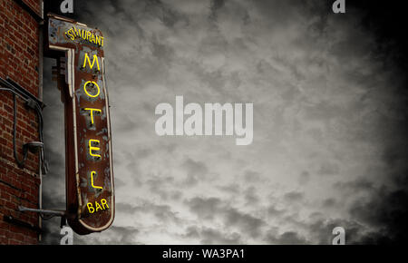 A Grungy Old Neon Motel Sign Against A Stormy Sky With Copy Space Stock Photo