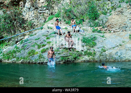 Nehrwa, Himachal Pradesh, india - April 20th, 2019: Boys swimming in fresh river water on a summer vacations Stock Photo