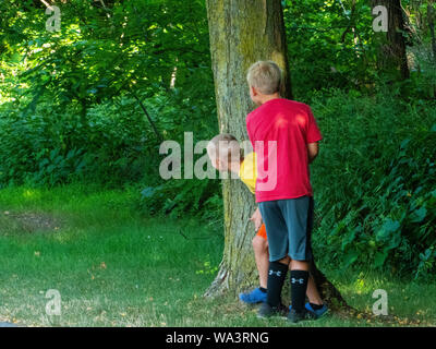 Boys playing hide and seek. Stock Photo