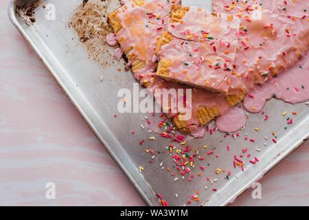 Closeup shot of a pap-tart cake treat on a metal baking tray Stock Photo