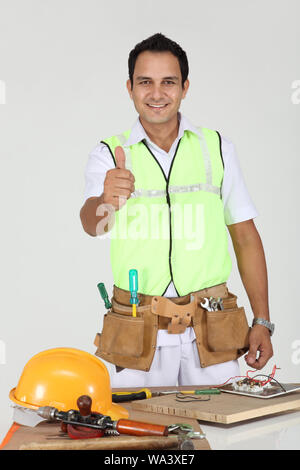 Electrician showing thumbs up sign Stock Photo