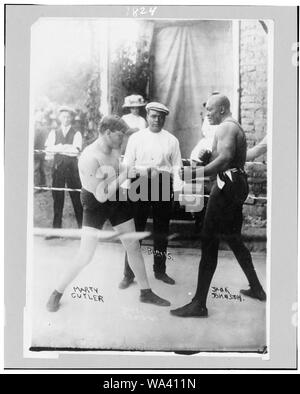 Boxers Marty Cutler and Jack Johnson in ring, with Burns, referee(?)] / D.W.A. photo-61 Stock Photo