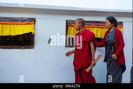 Kathmandu, Nepal-November 02,2017: religious Tibetan monk and women is walking around the Stupa of Bodnath in Kathmandu Stock Photo