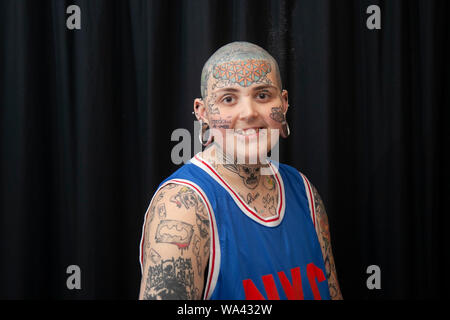 Aiden-lee Dawson (MR) with bald head, tatooed eyes and piercings; Tatcon tattoo festival opens in Blackpool. Tatcon Blackpool is an event held from August 16th to 18th 2019 at the Norbreck Castle Hotel in Blackpool, United Kingdom. This tattoo convention event showcases products like Tattoo equipments, apparel, accessories, jewelry, clothings, design, arts, tattoo supplies. Stock Photo