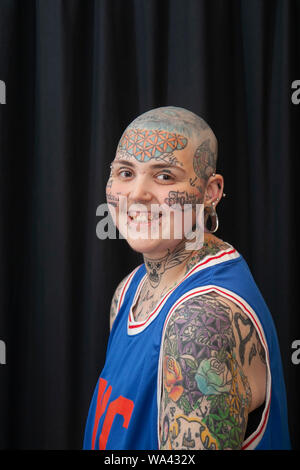 Aiden-lee Dawson (MR) with bald head, tatooed eyes and piercings; Tatcon tattoo festival opens in Blackpool. Tatcon Blackpool is an event held from August 16th to 18th 2019 at the Norbreck Castle Hotel in Blackpool, United Kingdom. This tattoo convention event showcases products like Tattoo equipments, apparel, accessories, jewelry, clothings, design, arts, tattoo supplies. Stock Photo