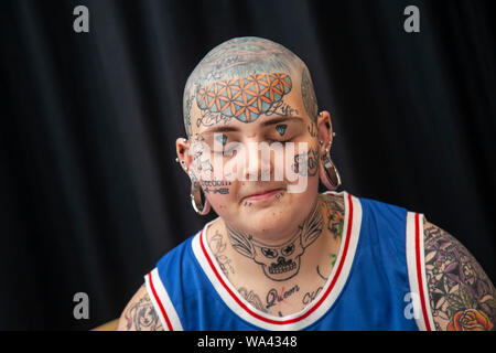 Aiden-lee Dawson (MR) with bald head, tattooed eyes and piercings; Tatcon tattoo festival opens in Blackpool. Tatcon Blackpool is an event held from August 16th to 18th 2019 at the Norbreck Castle Hotel in Blackpool, United Kingdom. This tattoo convention event showcases products like Tattoo equipments, apparel, accessories, jewelry, clothings, design, arts, tattoo supplies. Stock Photo