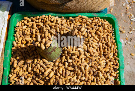 metal scooper in a pile of raw peanuts on a market in Asia Stock Photo