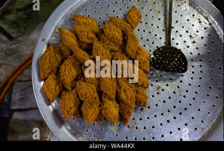 deep fried sweets cooked in an iron pan in Asia Stock Photo