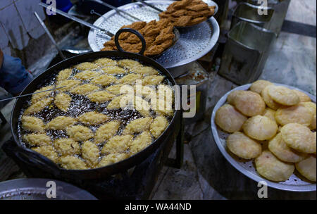 deep fried sweets cooked in an iron pan in Asia Stock Photo