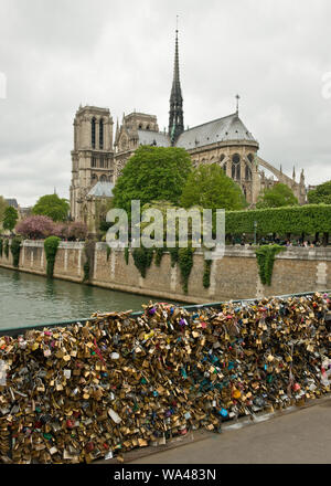 Pont de l'Archeveche bridge with love padlocks and Notre-Dame Cathedral. Paris, France Stock Photo