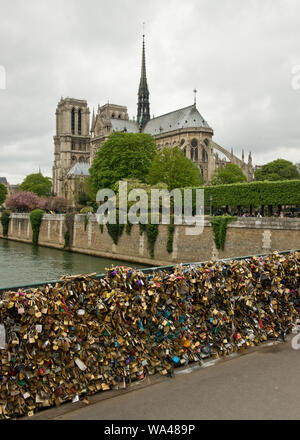 Pont de l'Archeveche bridge with love padlocks and Notre-Dame Cathedral. Paris, France Stock Photo