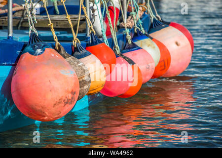 Colourful floats on fishing boat at Mousehole harbour Cornwall England GB UK EU Europe Stock Photo