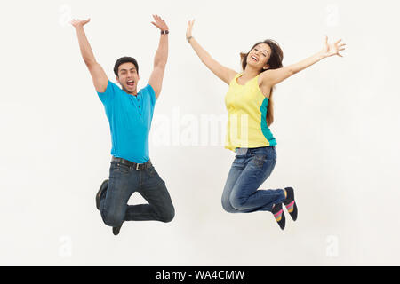 Young couple jumping in air Stock Photo