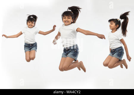 Multiple images of a girl jumping in air and smiling Stock Photo - Alamy