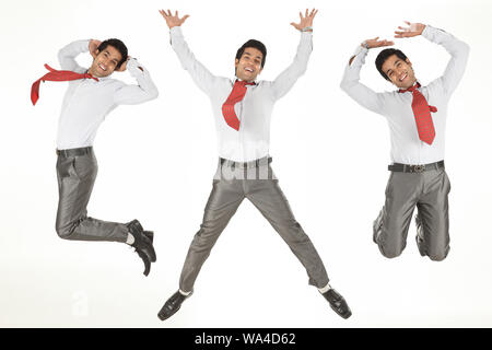 Multiple images of a businessman jumping in air and smiling Stock Photo