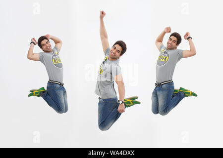 Multiple images of a young man jumping in mid air Stock Photo