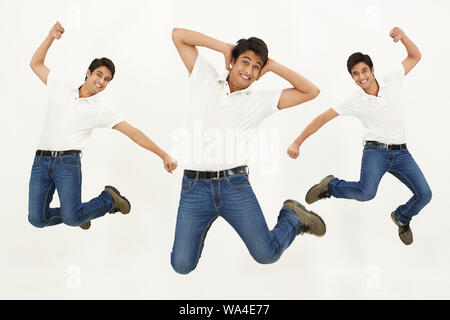 Multiple images of a young man jumping in air and smiling Stock Photo