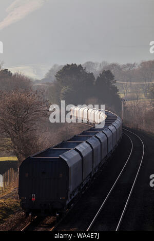 Empty GB Railfreight aggregates hopper train passing  Edale Derbyshire, on the Hope Valley line Stock Photo