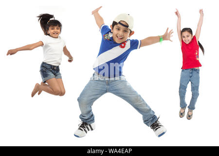 Group of friends jumping in air with arm outstretched Stock Photo