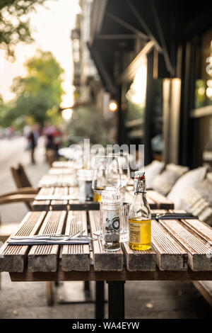 Cafe outdoor table setting with glasses and condimentsCafe outdoor table setting with glasses and condiments Stock Photo