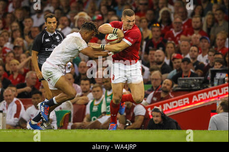 17th August 2019; Principality Stadium, Cardiff, Glamorgan, Wales; International Rugby Test Match, Wales versus England; George North of Wales evades the attempted tackle by Anthony Watson of England - Editorial Use Only. Stock Photo