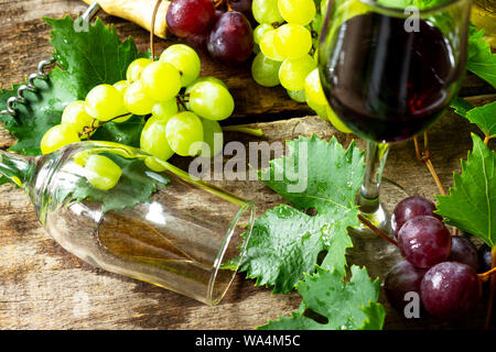 Wine concept. White and Red wine in glasses, bottle, grapes on vintage background. Stock Photo