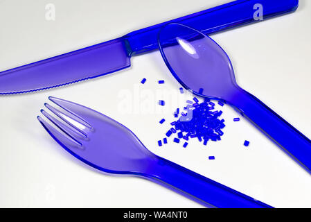 blue plastic cutlery made from polypropylene on white background with  correspondending polymer resin Stock Photo