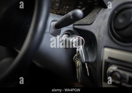 ignition key in the lock of an older car, selected focus, narrow depth of field Stock Photo