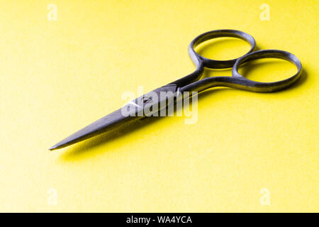vintage scissors on a yellow background Stock Photo