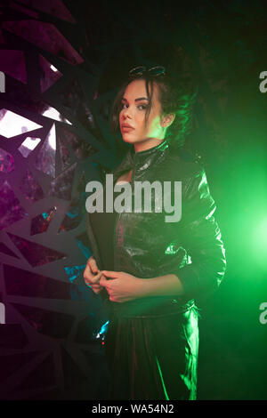 head of person in neon paint. girl close-up on black background. Stock Photo