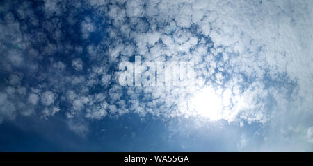 Deep blue sky with white fluffy clouds Stock Photo