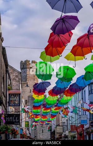 Multi-coloured umbrellas over Palace Street, Caernarfon, North Wales Stock Photo
