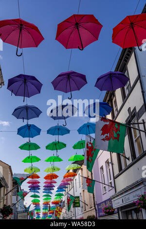 Multi-coloured umbrellas over Palace Street, Caernarfon, North Wales Stock Photo