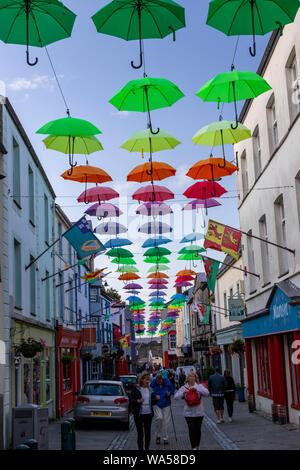 Multi-coloured umbrellas over Palace Street, Caernarfon, North Wales Stock Photo