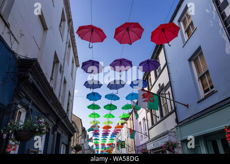 Multi-coloured umbrellas over Palace Street, Caernarfon, North Wales Stock Photo